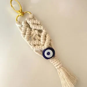 Handmade Macrame evil eye keychain with off-white cotton fringe and gold clasp