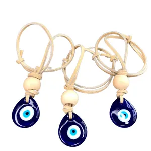 Three-piece evil eye pendants with blue glass teardrops, wood beads and leather cords