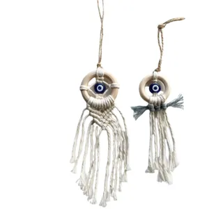 Handwoven Evil Eye wall hanging made of cotton rope and wooden ring in Boho style