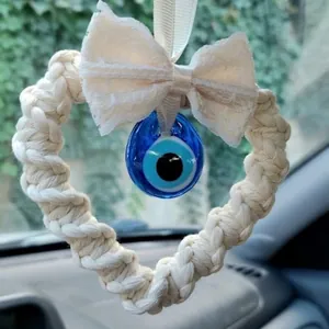 Handmade woven heart car pendant with white lace bow and blue evil eye glass bead charm