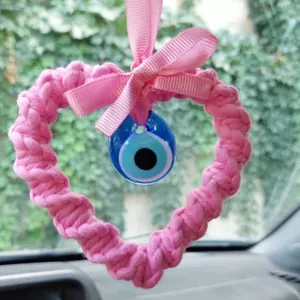 Pink handmade knit heart car charm with blue evil eye bead and ribbon detail