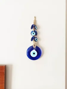 Macro detail of handmade evil eye wall hanging with glass beads and natural jute rope