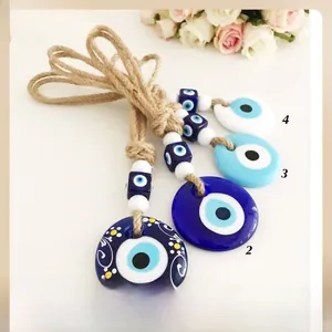 Detailed view of woven hemp ropes with blue glass evil eye pendants for wall decor