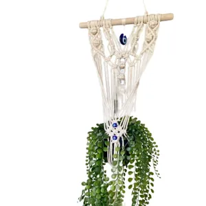 Bohemian handwoven macrame evil eye plant hanger with wooden rod for wall decoration