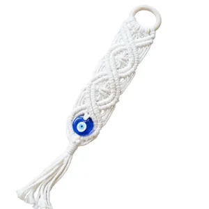 Handmade bohemian white cotton rope Evil Eye wall hanging with blue glass bead and tassels