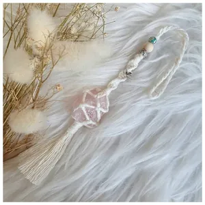 Detail of handmade macrame hanger with pink Himalayan salt stone and heart metal tag