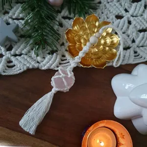 Detailed close-up of handmade pink Himalayan salt stone pendant with macrame weaving