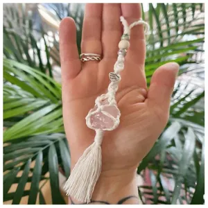 Close-up of handmade macramé holder with pink salt crystal and Made with Love charm