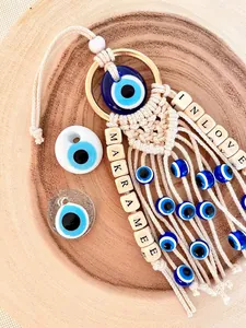 Handmade woven boho evil eye car hanging charm with cotton tassels and wooden beads