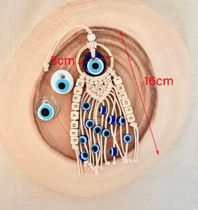 Handmade Macrame Evil Eye charm with blue beads and wood accents, length 16cm and width 5cm