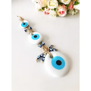 Blue Turkish evil eye wall hanging decor with three glass amulets and woven rope