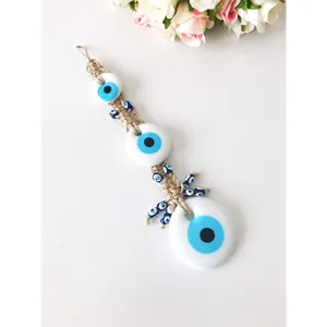 Handcrafted evil eye hanging ornament with blue glass beads and jute rope for home decor