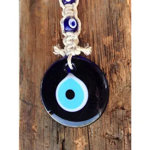 Handmade bohemian evil eye wall hanging with blue glass and woven cotton rope