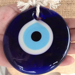 Handmade bohemian blue evil eye wall hanging charm with white woven rope detail