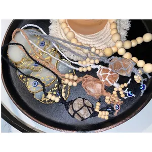 Detailed close-up of handmade woven Himalayan salt pendants with evil eye beads and wood beads