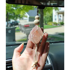Detail of handmade cotton woven net holding a natural pink salt crystal car hanging charm