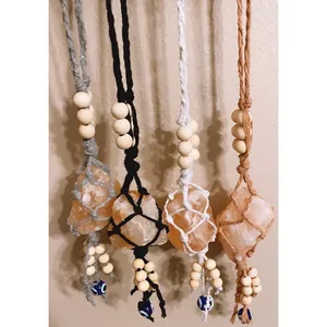 Detail of handmade macrame hanging ornaments with raw Himalayan salt and blue evil eye charms