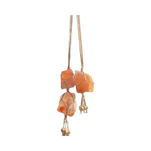 Handmade woven Himalayan salt stone wall hanging with orange crystals and tassels