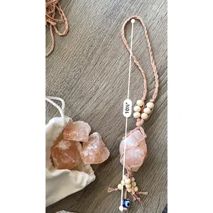 Detail of pink Himalayan salt car charm with evil eye bead and wood beads decoration