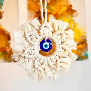 Handmade bohemian macrame evil eye wall hanging with cream cotton tassels
