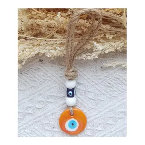 Handmade orange evil eye hanging ornament with natural jute rope and glass beads