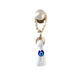 Bohemian Evil Eye wall hanging with wooden beads and a white decorative tassel