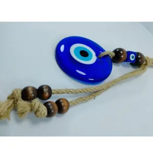 Turkish Evil Eye wall hanging with blue glass pendant, wooden beads and jute rope