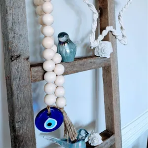 Minimalist wooden bead garland with blue evil eye pendant and rustic jute tassel hanging