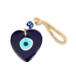Blue glass heart-shaped Turkish Evil Eye wall hanging with decorative bead and jute rope