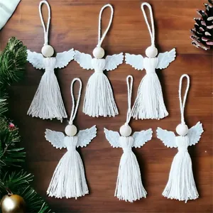 Close-up of 6-piece white macrame angel ornaments on dark wood for Christmas decor