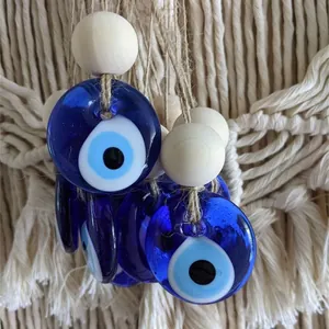 Macro shot of glass Evil Eye pendants with wooden beads on a boho woven background