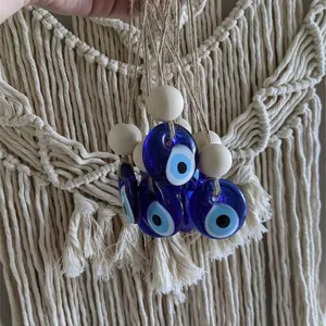Macro view of blue glass Evil Eye pendants with wooden beads and natural jute twine