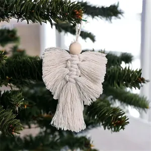 Handmade white macrame angel ornament with wood bead hanging on a green Christmas tree