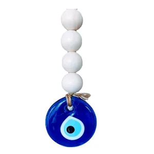 Minimalist evil eye wall hanging decor with blue glass pendant and natural wood beads