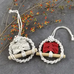 Handmade macrame Christmas tree ornaments with white and red tassels on wood bars