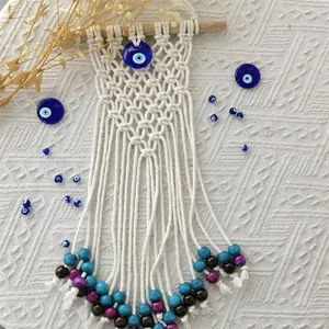 Bohemian handmade macrame wall hanging with blue evil eye beads and colorful accents