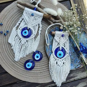 Handmade macrame Evil Eye wall hanging with cream cotton rope and wood rod decoration