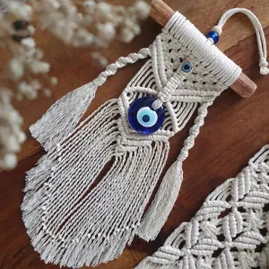 Handmade Evil Eye macrame wall hanging with blue bead and wooden stick for boho home decor