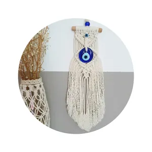Handmade Macrame Evil Eye wall hanging with cotton tassels and natural wooden rod