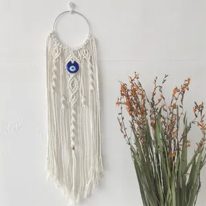 Handmade Macrame Evil Eye Wall Hanging with blue bead and bohemian cotton tassels