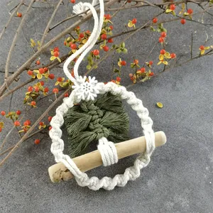 Handmade macrame Christmas tree ornament with green fringe and white snowflake decoration