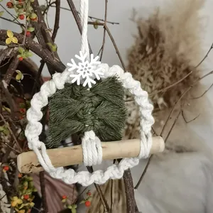Detailed macro view of macrame Christmas tree ornament with cotton rope and wood bar