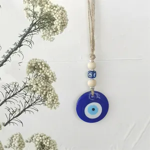 Decorazione da parete occhio di Allah fatta a mano con perle in vetro, legno e iuta