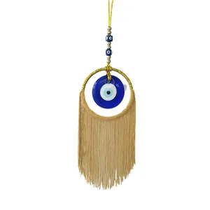 Décoration murale Evil Eye faite main avec œil en verre bleu et franges dorées