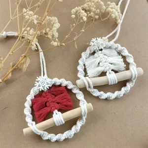 Detail view of handmade macrame Christmas tree ornaments with red and white cotton threads