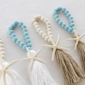 Detail of Mediterranean wood bead tassels with realistic starfish on gray background