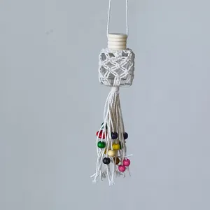 Detail of hand-woven bohemian perfume bottle charm with colorful beads and long tassels