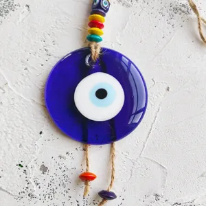 Handmade Evil Eye wall hanging with colorful beads and glass nazar charm on a jute rope