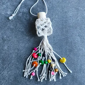 Handmade macrame essential oil car diffuser bottle with colorful beads and long tassels