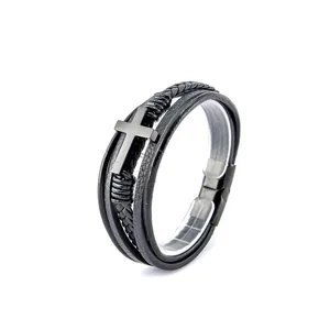 Détail du bracelet en cuir noir multicouche avec croix en métal gris mat poli